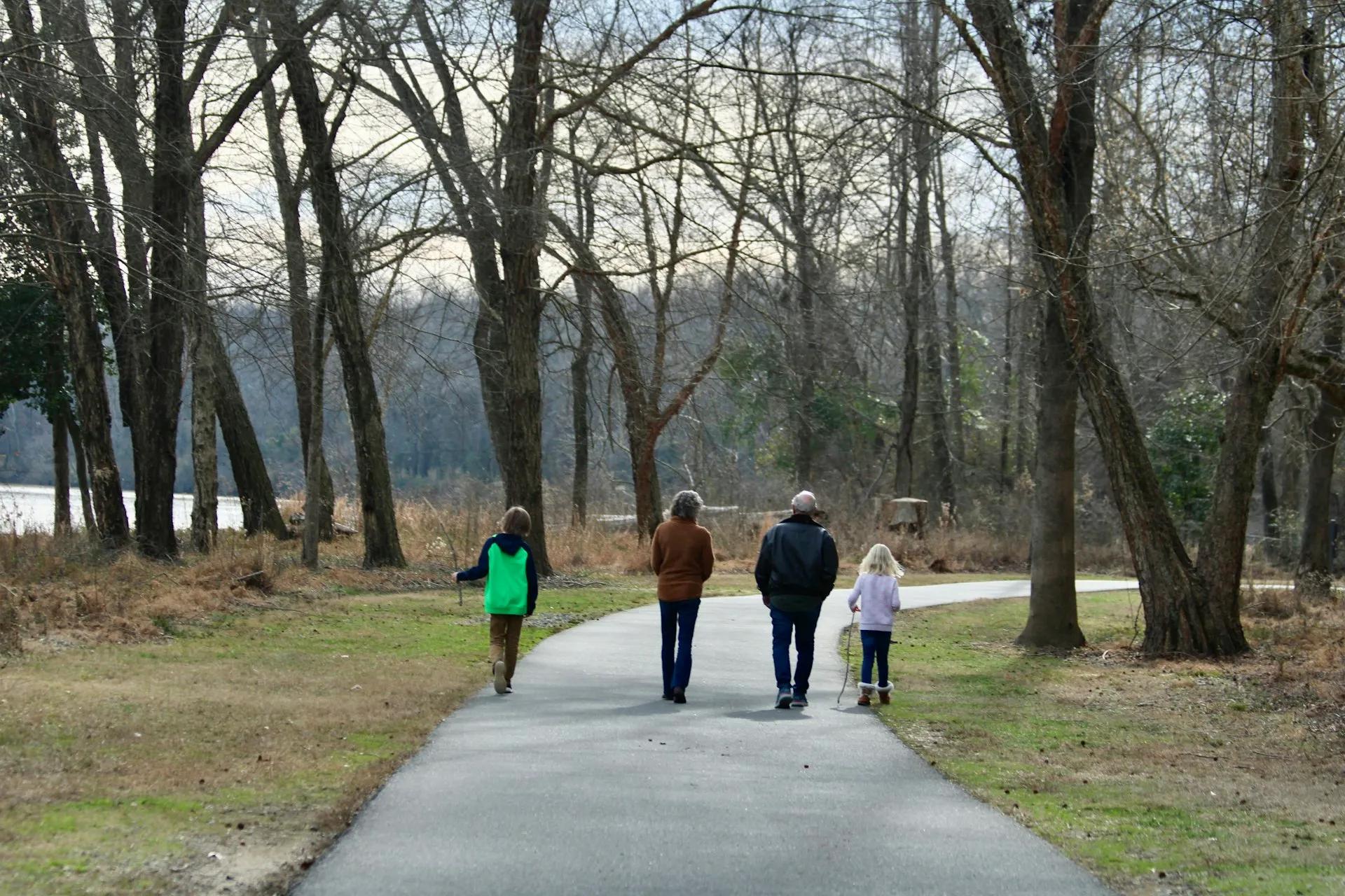 Families and neighbors enjoying a walk along a scenic park trail